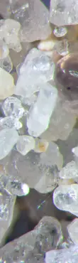 Microscopic view of mineral and sediment particles.