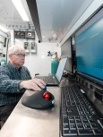 Environmental scientist analyzing monitoring data in a mobile laboratory