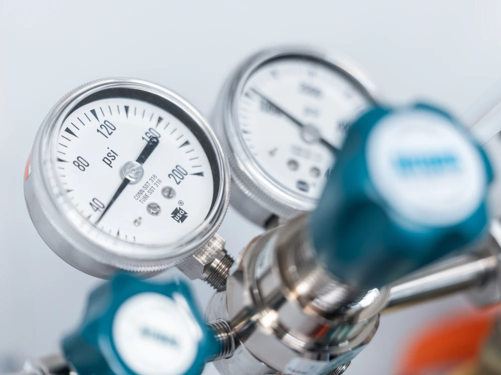 Close-up of industrial gas pressure gauges and regulator valves