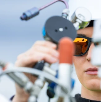 Environmental professional using field monitoring equipment outdoors.