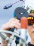 Environmental professional using field monitoring equipment outdoors.