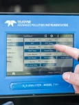 Digital environmental monitoring equipment displaying air quality data.