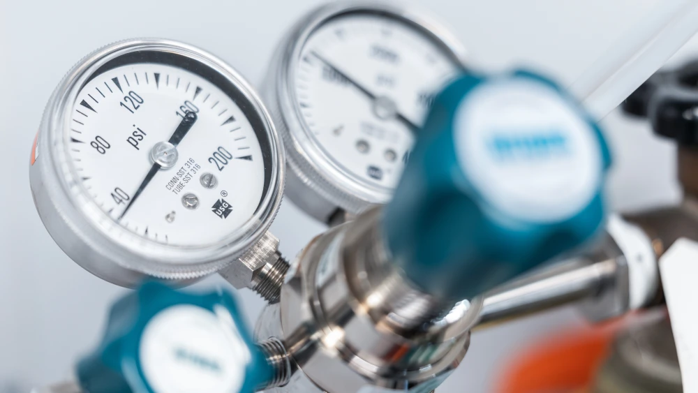 Close-up of industrial gas pressure gauges and regulator valves