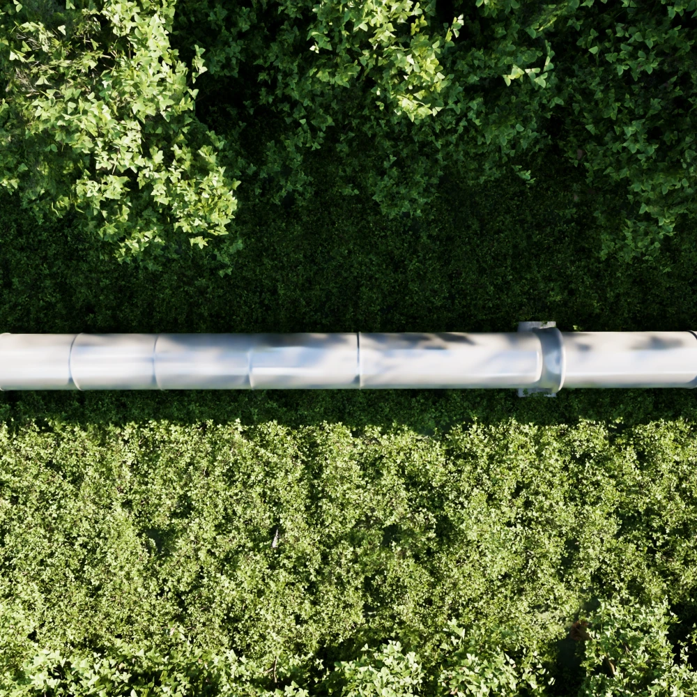 Aerial view of a pipeline running through a green forest landscape