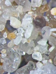 Microscopic view of mineral and sediment particles.