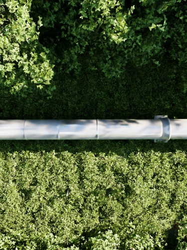 Aerial view of a pipeline running through a green forest landscape