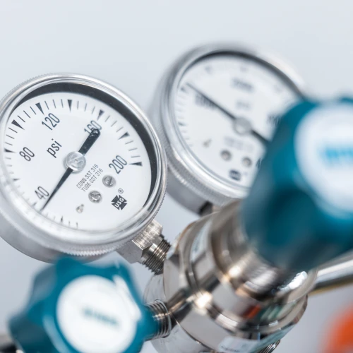 Close-up of industrial gas pressure gauges and regulator valves