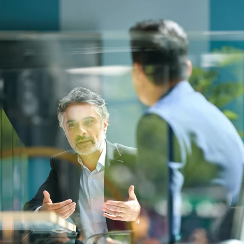 Man explaining a concept during a business meeting with a colleague in an office