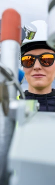 Technician inspecting industrial equipment and control valves outdoors
