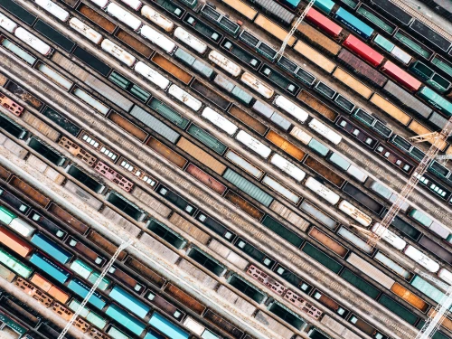 Aerial view of a rail yard with multiple freight trains and tracks arranged in parallel lines