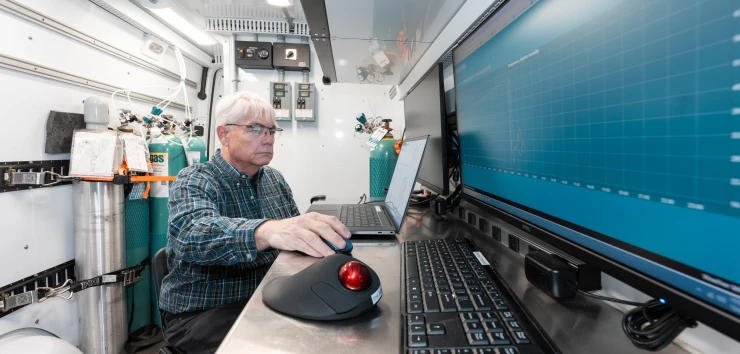 Environmental scientist analyzing monitoring data in a mobile laboratory